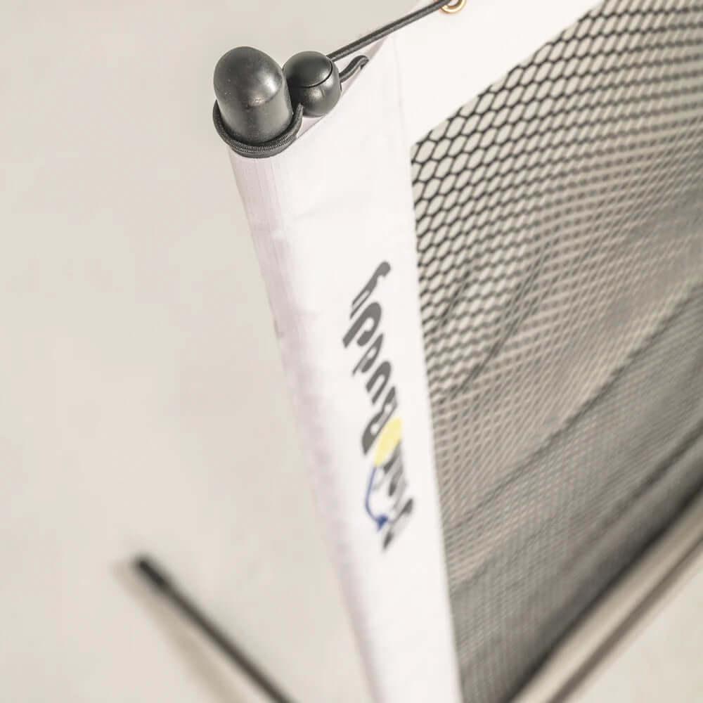 Close-up of portable sports net with mesh and white post, logo partially visible