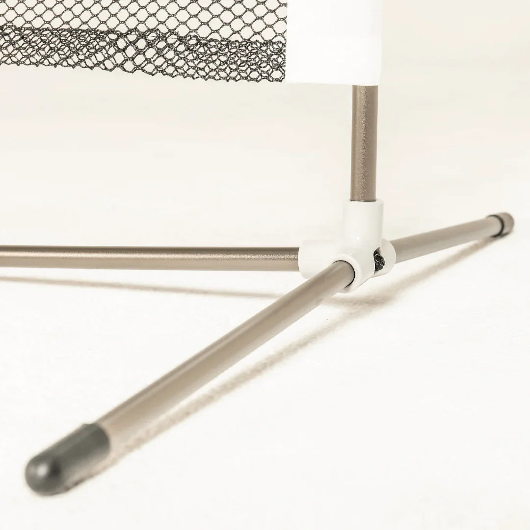 Metal tripod leg base with plastic connector and black netting on light background