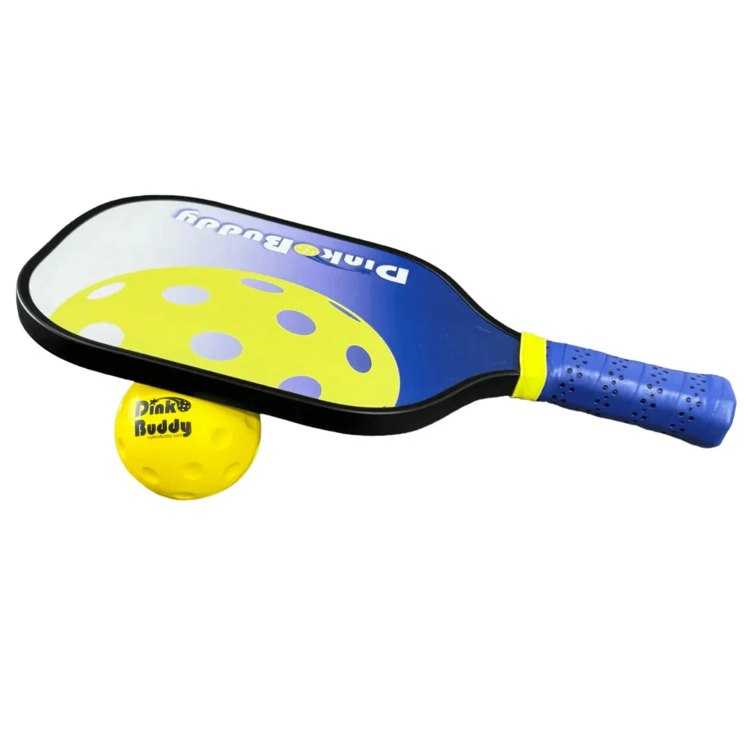 Children's pickleball paddle with blue grip and yellow Dink Buddy ball on white background