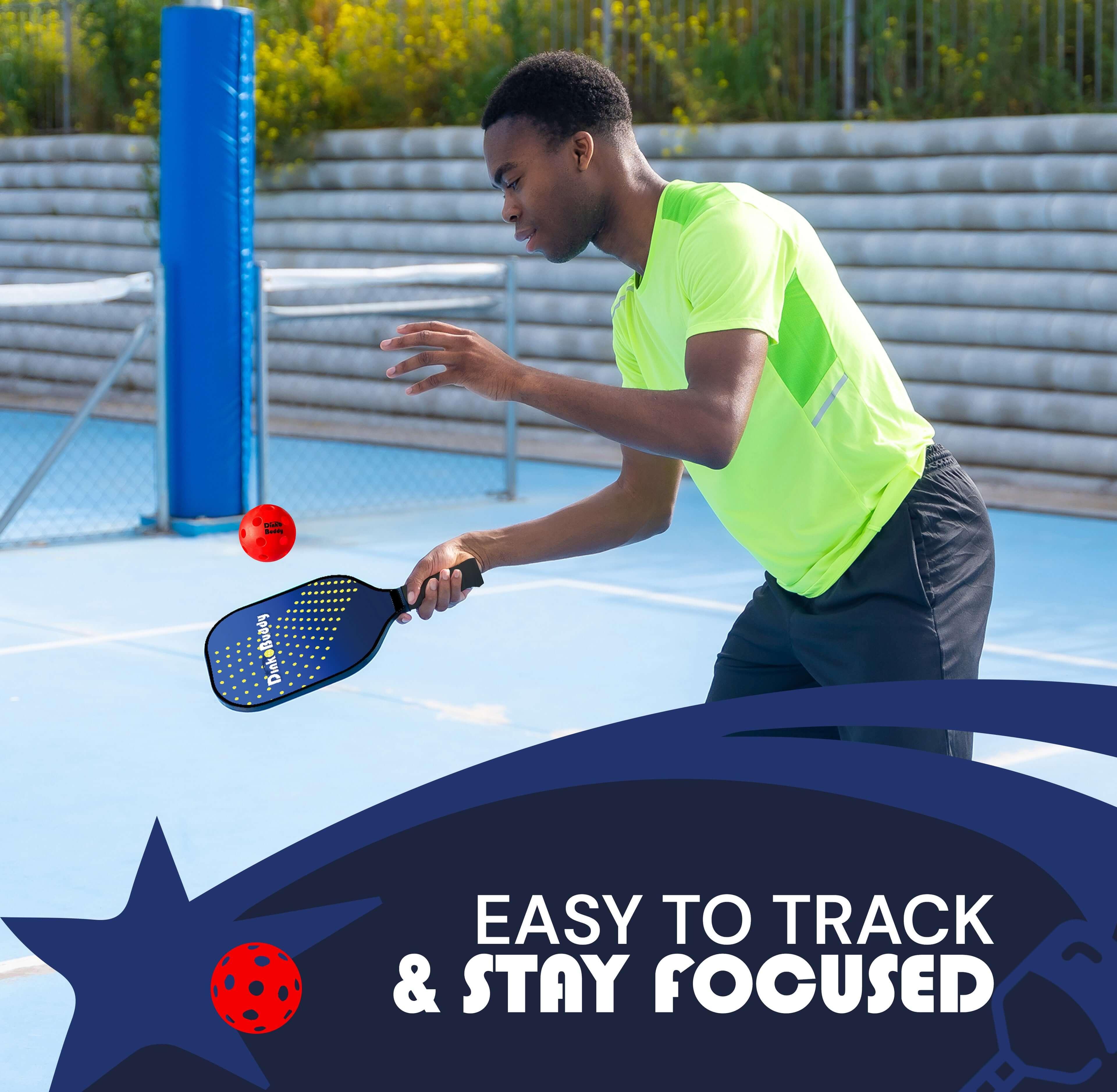 Man playing pickleball with blue paddle and red ball on outdoor court, easy to track and stay focused.
