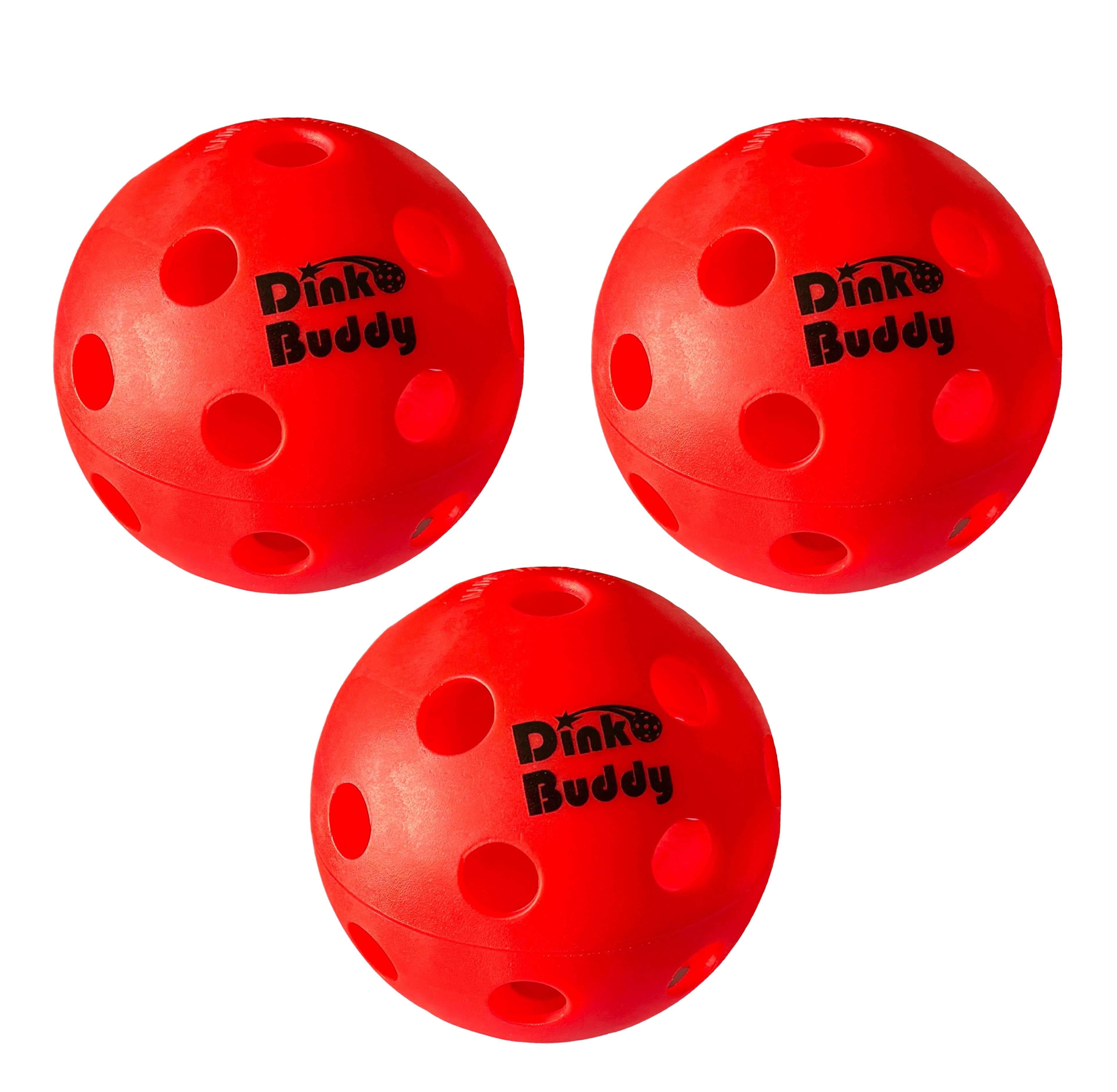 Three red Dink Buddy pickleball balls with holes on white background