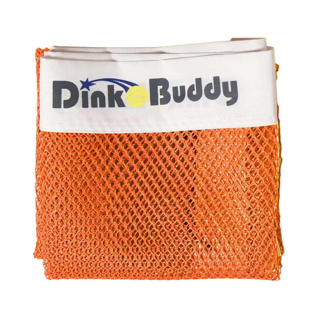Folded orange mesh net with white Dinko Buddy logo band for pickleball accessories
